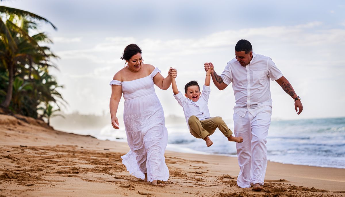 A smiling family walking together on the beach